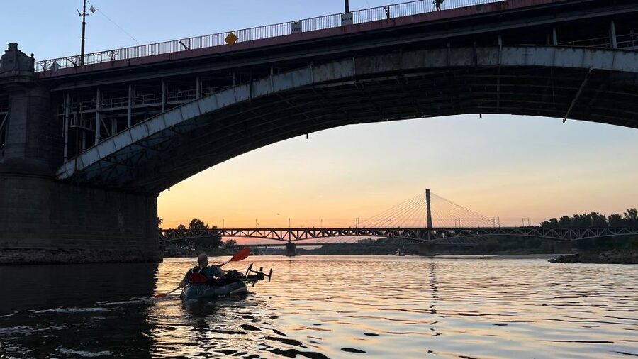 Packrafting kayaking guided tour Vistula river Warsaw Poland - The Old Town at sunset